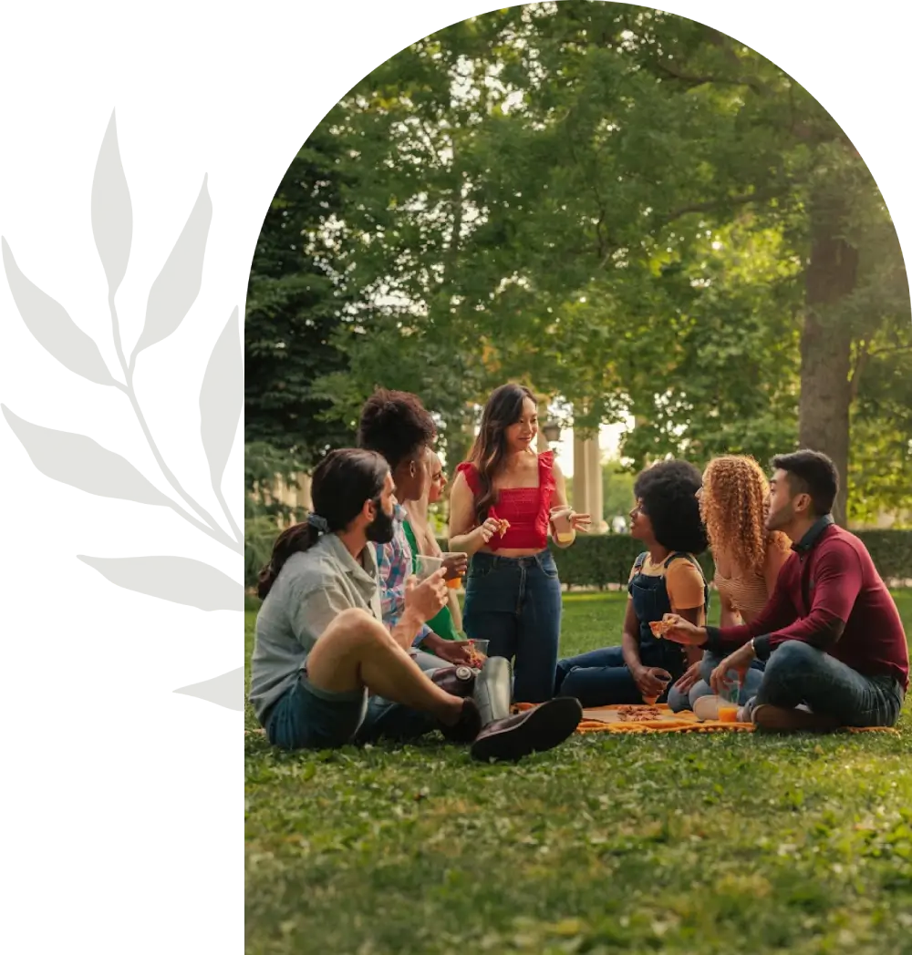 A group of friends enjoying a picnic outdoors on a sunny day.